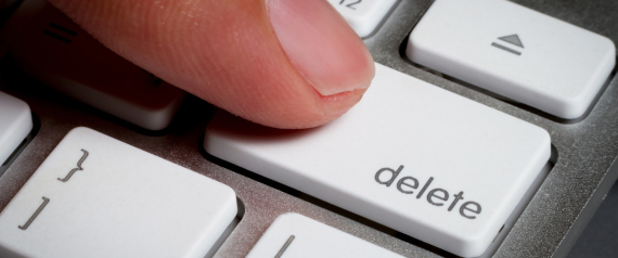 Closeup of finger on delete key in a keyboard.