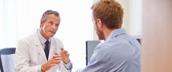 Male Patient Having Consultation With Doctor In Office