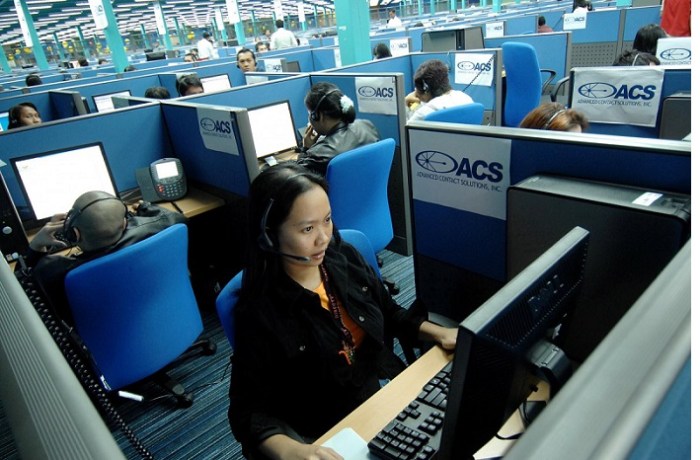 إحدي موظفات في مركز اتصالات في كويزون سيتي في مانيلا عاصمة الفلبين تقوم بخدمة عملاء من الولايات المتحدة، تخشي الفلبين أن يهدد الذكاء الإصطناعي مراكز اتصالاتها